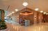 Modern apartment lobby featuring stylish wooden paneling, sleek terrazzo flooring, and elegant overhead lighting with a welcoming reception area.