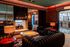 Luxurious lounge with elegant leather sofas, ambient lighting, and a modern fireplace, exuding sophistication and style.