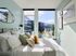 Bright and cozy bedroom with large windows, stylish decor, and a stunning city view.