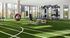 Modern fitness center with lush green turf, state-of-the-art gym equipment, and floor-to-ceiling windows offering vibrant outdoor views.
