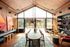 Chic modern living space with a long dining table, vibrant wall art, and abundant natural light, ideal for entertaining and relaxation.