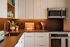 Modern kitchen design featuring sleek cabinetry, stainless steel appliances, and elegant countertop with stylish decor.