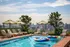 Luxurious rooftop pool area with colorful inflatables, stylish loungers, and stunning cityscape views for ultimate relaxation.