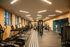 Contemporary fitness center featuring state-of-the-art treadmills, weightlifting area, and spacious interior with natural lighting.