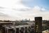 Charming urban view featuring a vibrant city skyline, historic buildings, and a unique rooftop space in the foreground, perfect for city living enthusiasts.