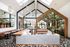 Chic, modern caf&eacute; interior with a sunlit, vaulted ceiling, vibrant greenery, and elegant pendant lighting.