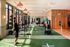 Modern fitness center with large windows, state-of-the-art equipment, and vibrant exercise areas.