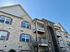 Charming apartment building with modern brick and stone exterior, featuring balconies and stylish design.