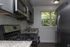 Modern kitchen with sleek stainless steel appliances, granite countertops, and a bright window view, perfect blend of style and functionality.