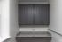 Elegant kitchen nook with sleek gray cabinets and a stylish granite countertop, perfect for modern living.
