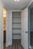 Inviting hallway with elegant built-in shelving and an adjacent bathroom with modern fixtures, perfect for streamlined storage in style.