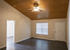 Inviting living room with elegant wood-paneled ceiling, modern floor, and ample natural light from large windows.