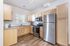 Bright, modern kitchen with stainless steel appliances, sleek wood cabinets, and elegant granite countertops.