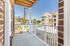 Charming balcony view overlooking modern apartment complex with contemporary architecture and lush greenery.
