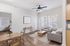 Bright and airy living space with modern furniture, wooden flooring, and natural light streaming through large windows, adjacent to a cozy dining area.