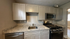 Modern kitchen with sleek cabinetry, stainless steel appliances, and elegant granite countertops.