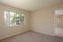 Agora at Port Richey, bedroom, large window with vertical blinds, door to living room, carpet