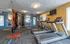 Modern apartment gym featuring state-of-the-art treadmills, vibrant decor, and a spacious workout area with natural light.