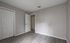Bright and spacious room featuring elegant grey flooring and neutral walls, perfect for customization.