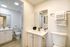 Bright and modern bathroom featuring a sleek vanity, chic mirror, and elegant fixtures.