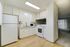 Modern kitchen design with white cabinetry, sleek appliances, and stylish flooring.