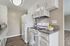Bright and modern kitchen with sleek white cabinetry, granite countertops, and stainless steel appliances. Featuring a charming bowl of fresh lemons for a touch of color.