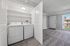 Bright and inviting laundry nook with modern washing and drying machines, seamless access to the cozy living area, and an abundance of natural light.
