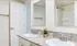 Elegant bathroom with dual sinks, sleek granite countertops, and a modern shower area.