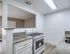 Modern kitchen with sleek granite countertops, contemporary white cabinetry, and a stainless steel stove, showcasing elegant design.