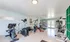Bright and airy gym space with modern exercise equipment, blue walls, and large windows offering plenty of natural light.