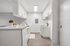 Sleek modern kitchen with white cabinetry, stylish countertops, and ambient lighting, perfect for culinary creativity.