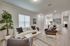 Luxe of Prosper | Apartments in McKinney | Rental in McKinney | Elegant open-plan apartment living room, cozy seating area, and bright kitchen.