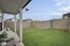 Luxe of Prosper | Apartments in McKinney | Rental in McKinney | Charming outdoor patio with cozy seating overlooking a lush green garden and modern fencing, perfect for relaxation.
