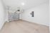 Spacious and versatile garage with pristine white walls, modern overhead door, and ample storage potential.