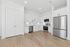 Sleek modern kitchen with stainless steel appliances, elegant white cabinets, and warm hardwood floors, perfect for culinary creativity.