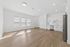 Bright and spacious open-concept living area with sleek hardwood floors and modern kitchen.