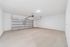 Spacious and clean two-car garage with sleek automatic door and ample lighting.