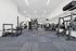 Spacious and modern gym with state-of-the-art equipment, perfect for fitness enthusiasts seeking a bright and airy workout environment.