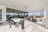 Spacious covered patio with modern dining set and cozy seating area, ideal for outdoor relaxation and entertaining.