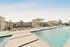 Elegant outdoor pool area with stylish cabanas and comfortable lounge chairs, perfect for relaxation and enjoying sunny days.