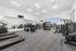 Spacious and modern fitness center with state-of-the-art exercise equipment, offering a bright and inviting workout environment.