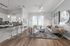Modern apartment interior with an open-concept living room and kitchen, featuring sleek bar stools, contemporary lighting, and stylish decor.