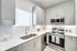 Modern kitchen with sleek cabinetry, stainless steel appliances, and bright natural lighting.