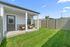Charming backyard with lush green lawn and cozy patio chairs, perfect for relaxation and outdoor enjoyment.