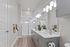 Elegant bathroom with dual sinks, modern fixtures, and chic glass shower in a bright and spacious design.