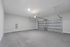Spacious modern garage with sleek gray floors and an automatic door, perfect for secure parking and storage.