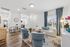 Contemporary open-plan living room with elegant furniture, modern decor, and bright natural light.