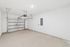 Spacious, well-lit garage with modern garage door and ample storage potential in a sleek apartment.