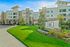 Elegant apartment complex 'The Luxe at Mercer Crossing' featuring modern architecture and beautifully landscaped surroundings.