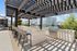 Chic outdoor living space featuring modern pergola, sleek bar stools, and a premium grill for entertaining.